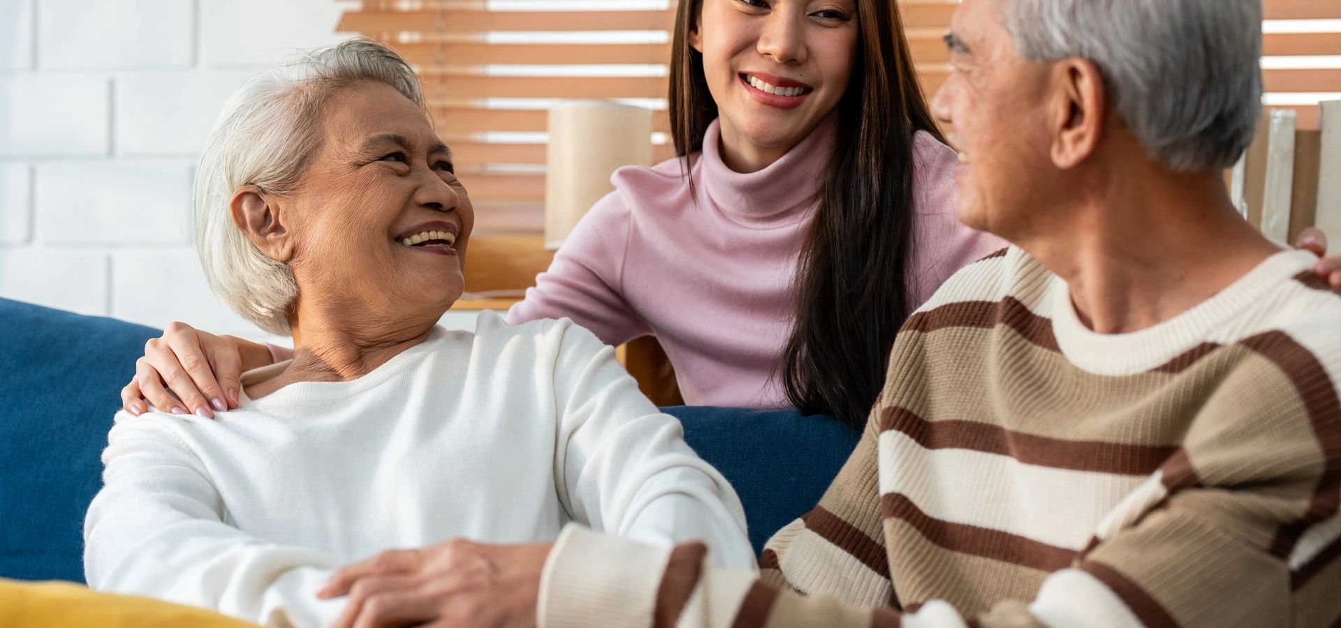 Senior resident with family in a warm living space